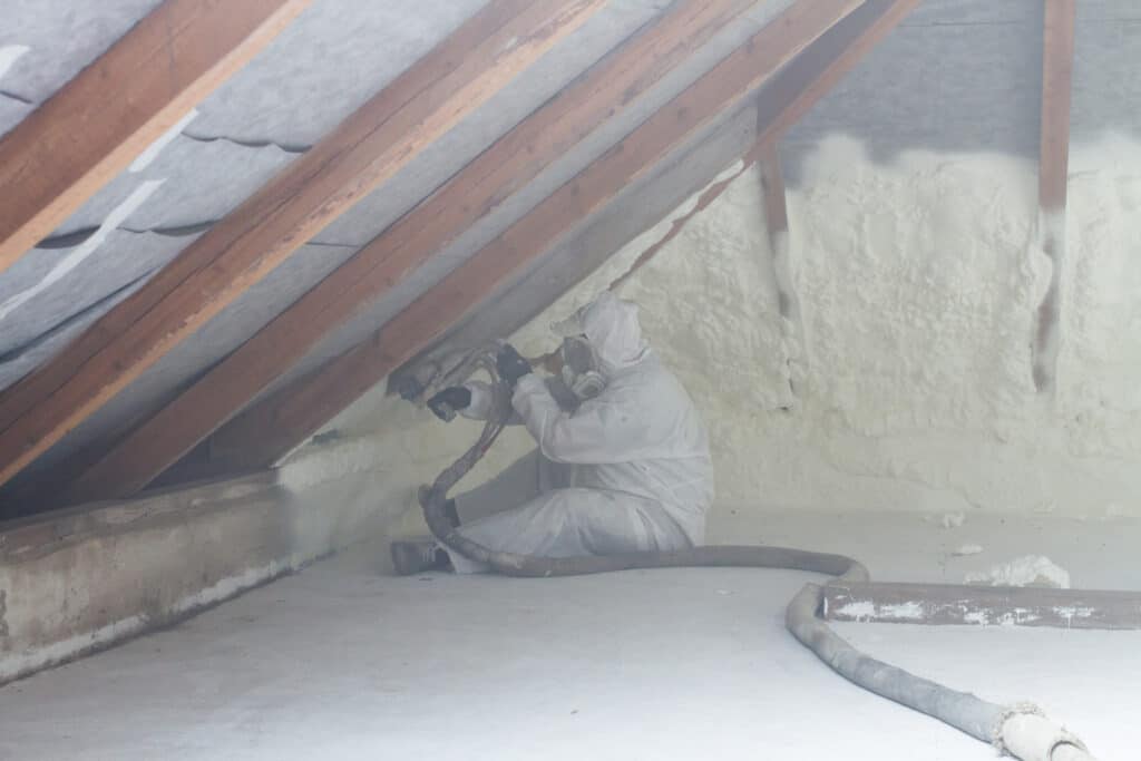 Spray Foam Insulation Being Applied To Attic