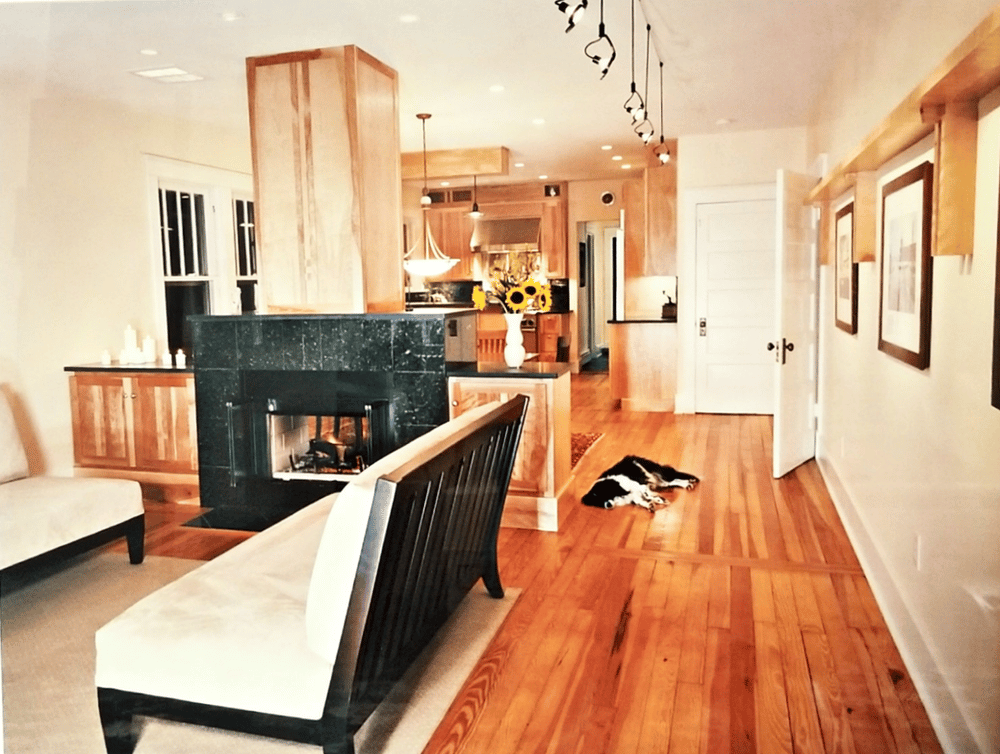 photo of interior house with wooden floors and fireplace
