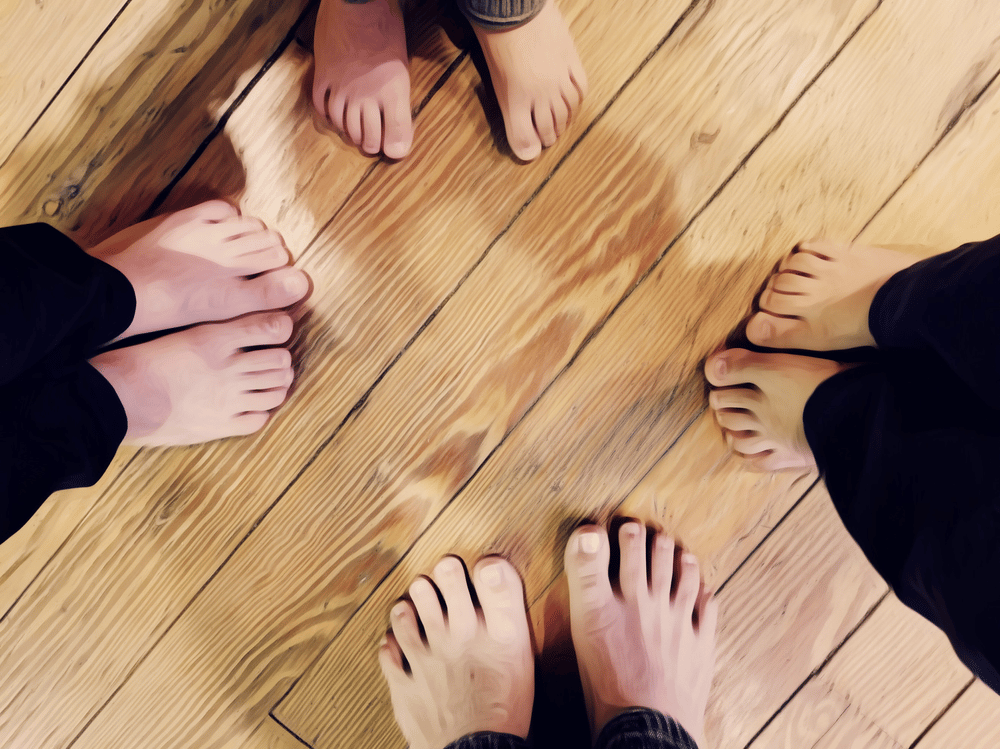 photo of family's feet on wooden floor