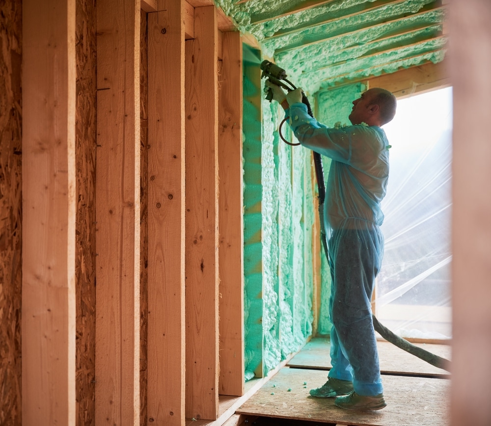 Man using spray foam insulation
